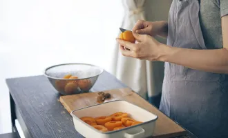 Hands slicing apricots.