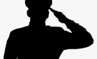 Saluting soldier in silhouette.