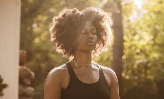 Woman breathing in sunlight.