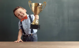 Child holding a trophy.