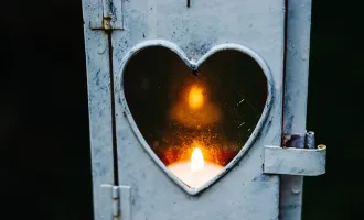 Candle in heartshaped holder.