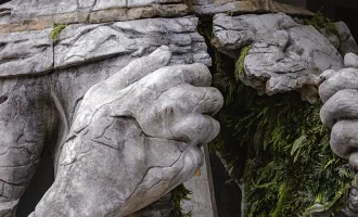 Statue breaking open chest.