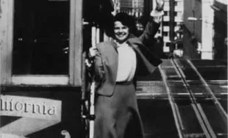 Dianne Feinstein riding a cable car.