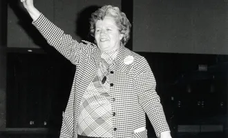 Wilma Scott Heide holding up a fist 
