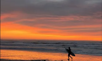 Surfer on a sunset beach
