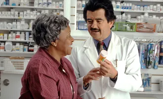 Pharmacist speaking with patient.