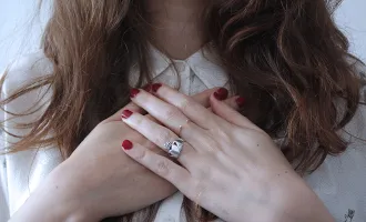 Hands clutching chest.