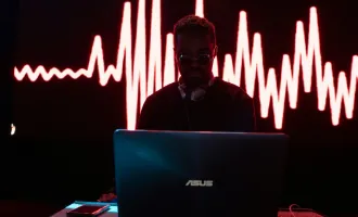 Man sitting at computer with heart graph.