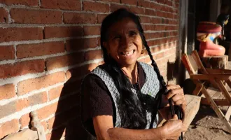 Woman braiding hair.