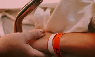 Holding a patient's hand.