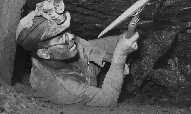 Miner swinging a pick.