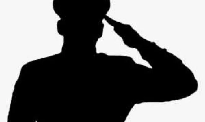 Saluting soldier in silhouette.