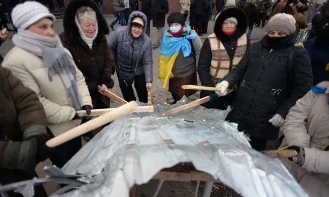 Women banging tin in protest.