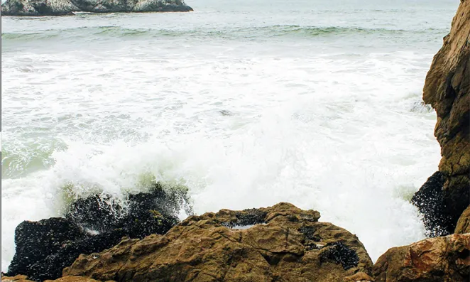 Waves crashing on rocky shore.