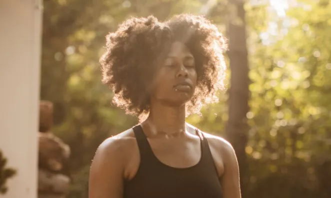 Woman breathing in sunlight.