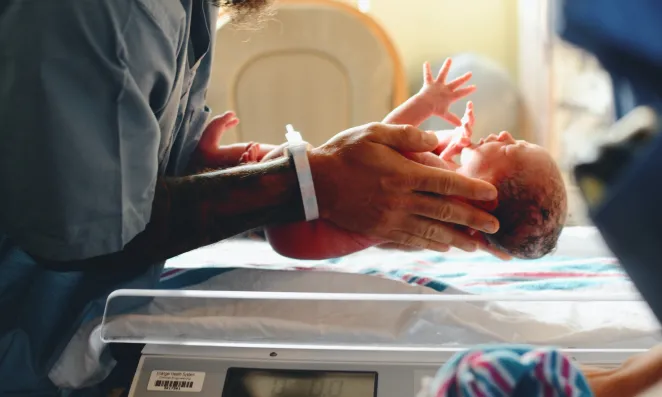 Man holding newborn