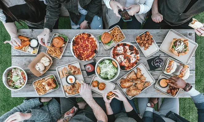 Friends sitting around a Thanksgiving spread.