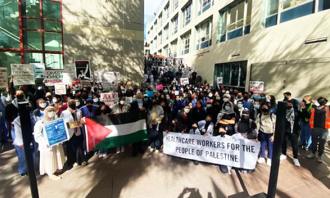 A crowd gathered with banners proclaiming support for the Palestinian people.