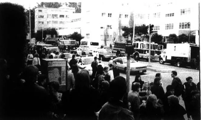 Evacuated crowd gathers outside UCSF Medical Sciences building.