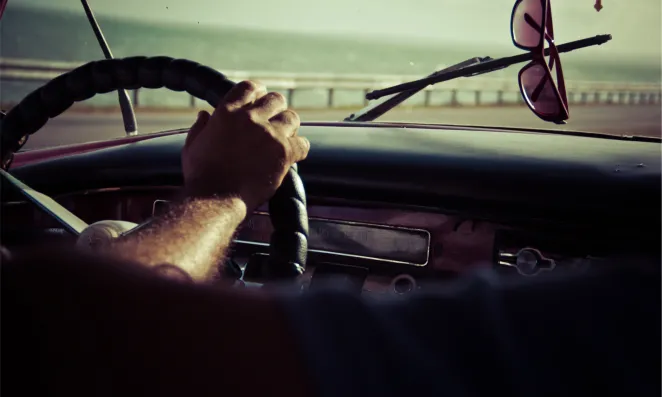 Hands on steering wheel.