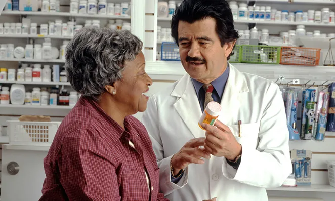 Pharmacist speaking with patient.