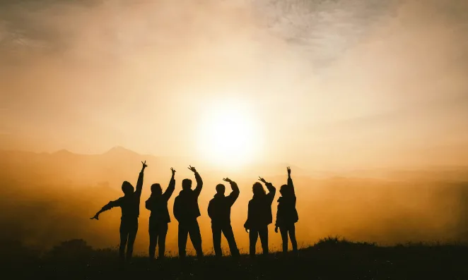 People on a beach at sunset