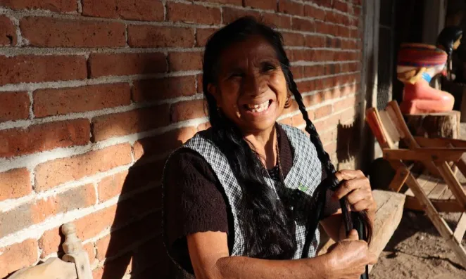Woman braiding hair.
