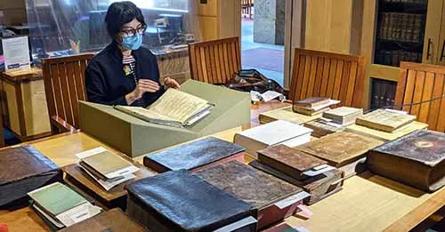 Artist Pantea Karimi with library books.