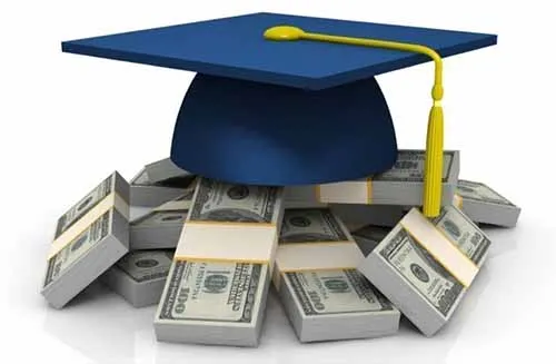 Graduation cap on top of piles of cash.