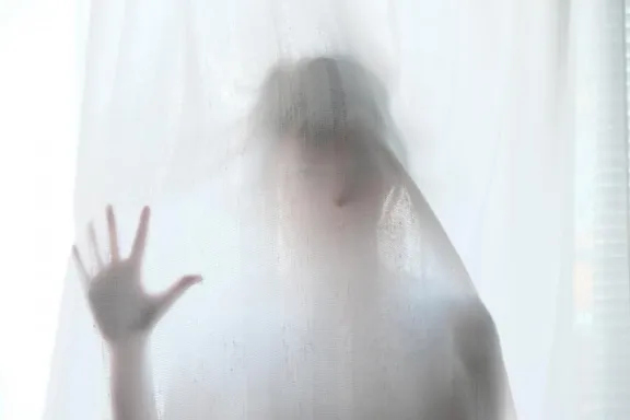 A ghostly figure behind a sheet.
