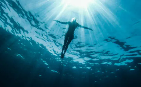 Woman floating in ocean.