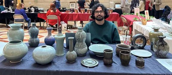 Asa Kalish shows off their wares at the Artisan Guild by the Bay winter handmade market on Dec. 6 at Mission Bay Genentech Hall Atrium.