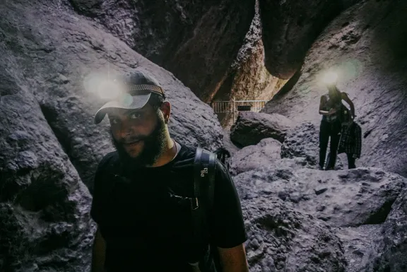 Headlamps light up dust particles at Pinnacles National Park. 