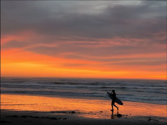 Surfer on a sunset beach