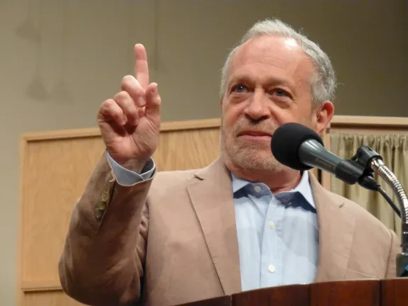 Image of Dr. Robert Reich at a podium.